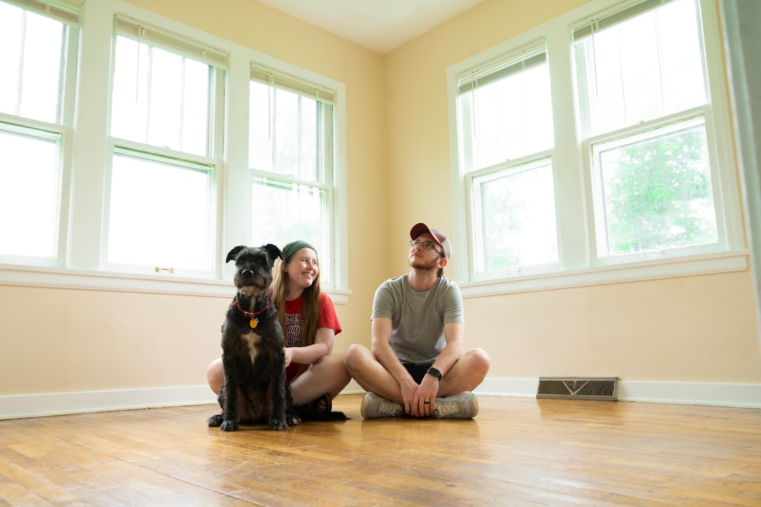 A calm dog sitting in a cozy living room, surrounded by its new family members, showcasing a welcoming environment.